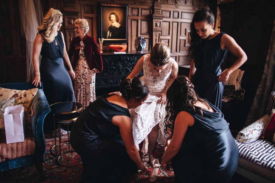 Guest-of-honour is helped into shoes