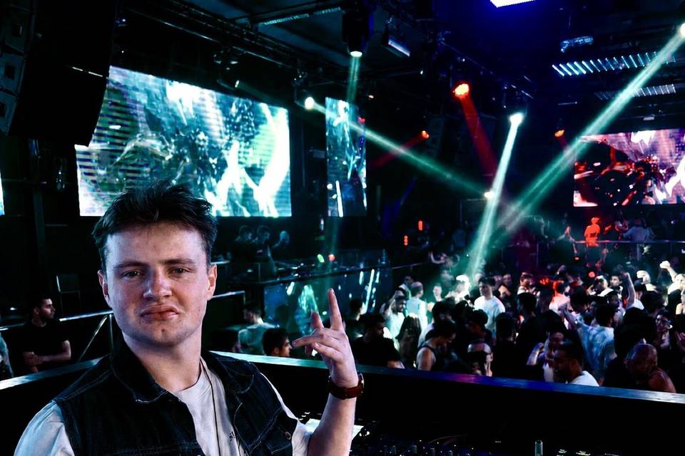 On the decks at a packed club night