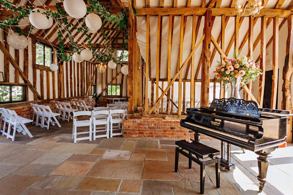 Barn ceremony space with piano