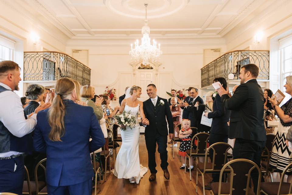 Couple walking down aisle