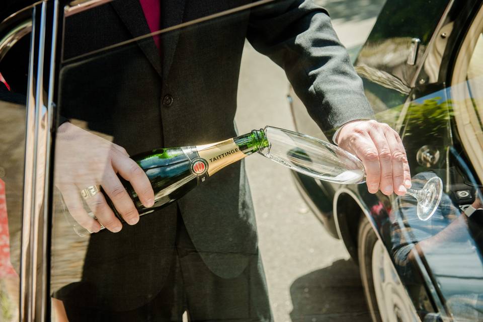 Chauffeur pouring champagne