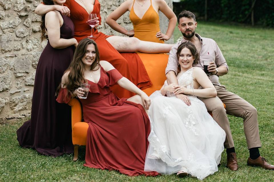 Bridesmaids pose on sofa