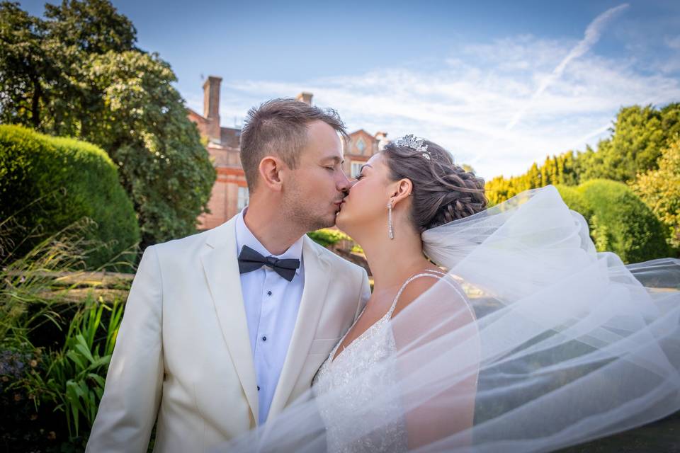Couple kiss in sunlit garden