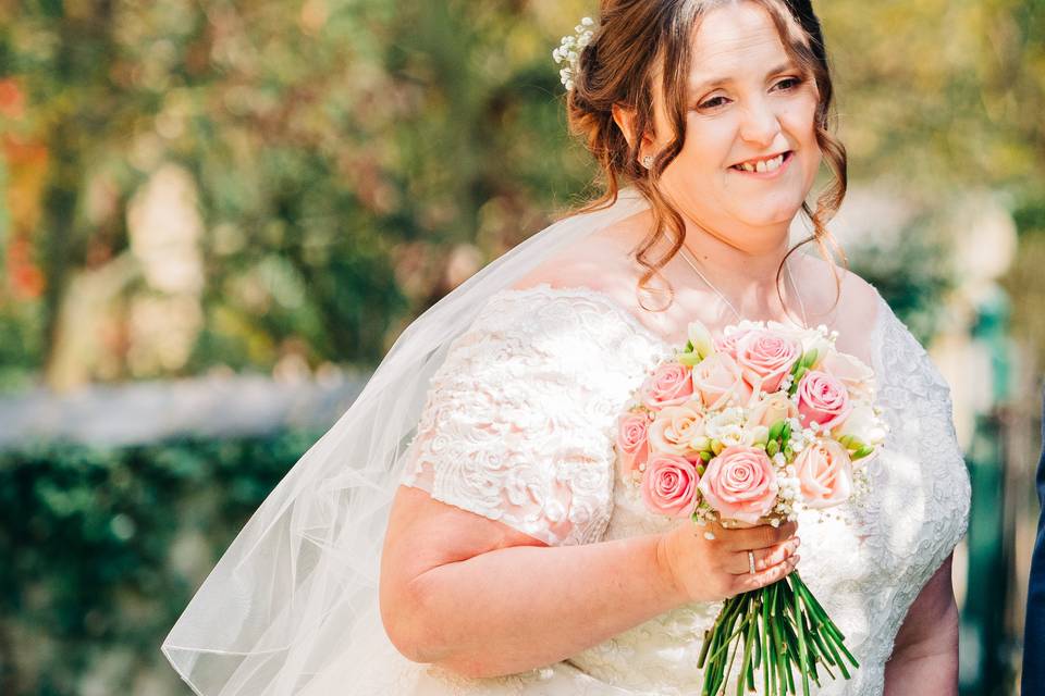 Smiling bride with bouquet