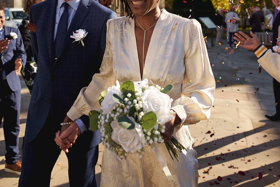 Couple walk through confetti