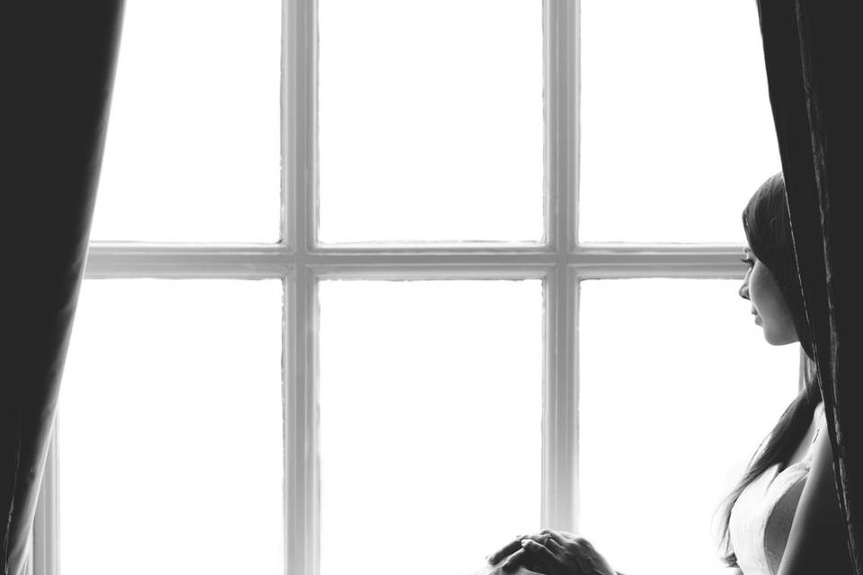 Bride poses in a window
