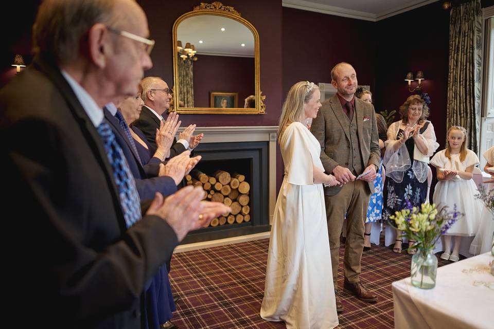 Guests applaud the couple