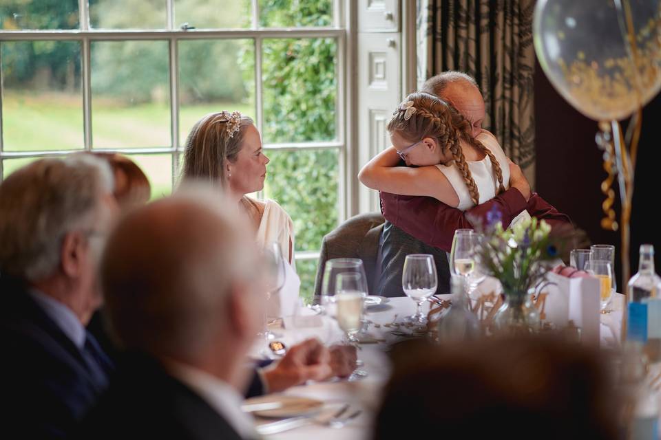 Daughter hugs the groom