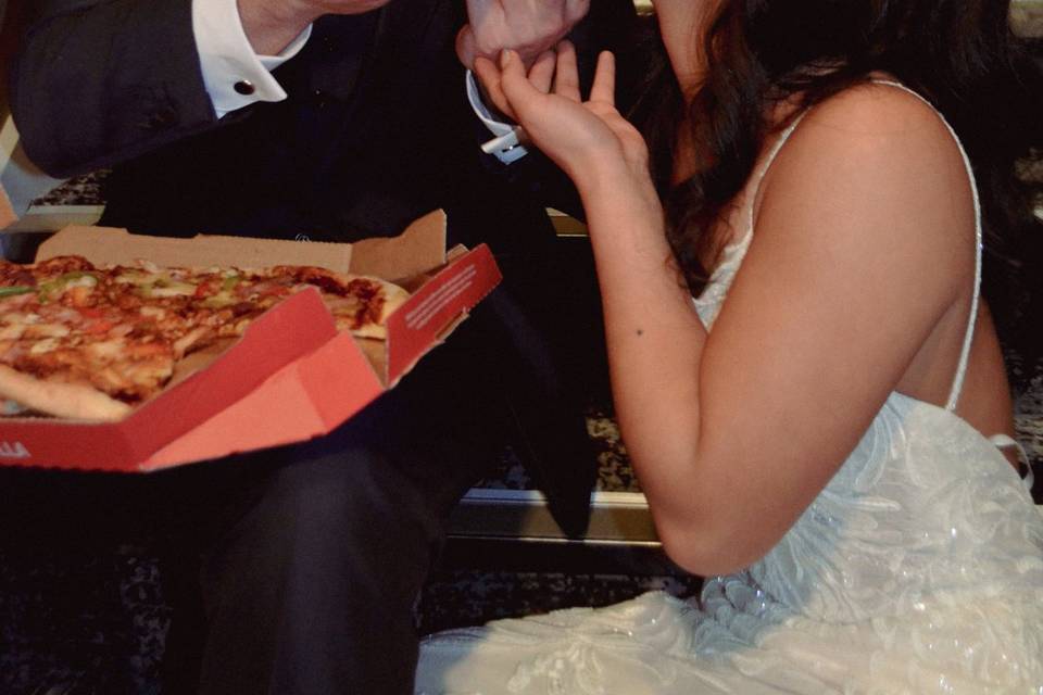 Sharing pizza - rookery hall wedding 2023