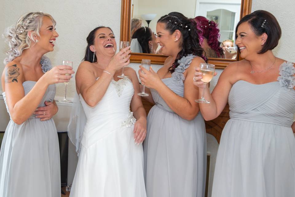 Bride & bridesmaids laughing