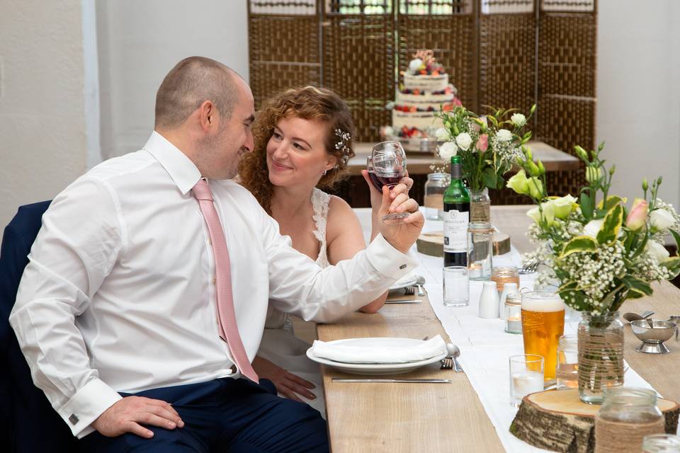 Bride and groom by the cake