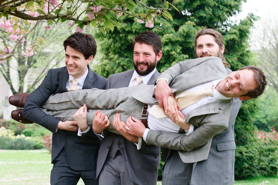 Groomsmen carrying the groom