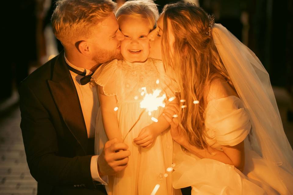Couple Kissing Their Child