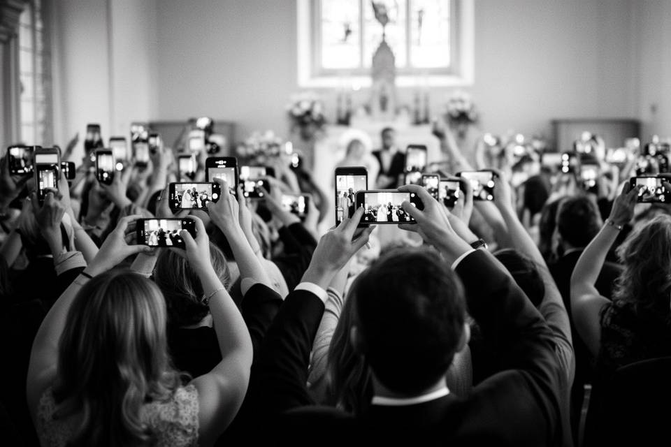 Wedding guests capturing the ceremony