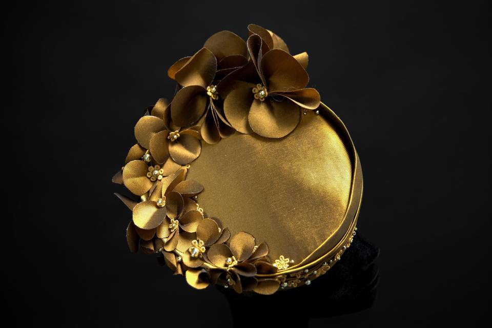 Gold pillbox hat with flowers