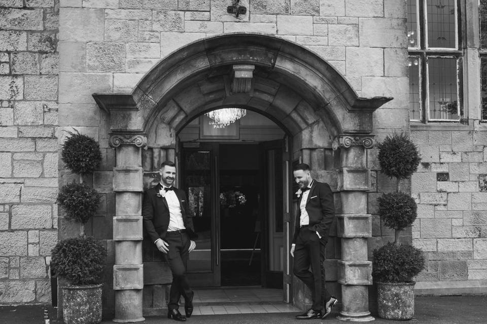 Grooms outside wedding venue