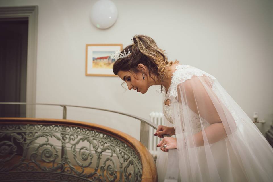 Bride peering over balcony