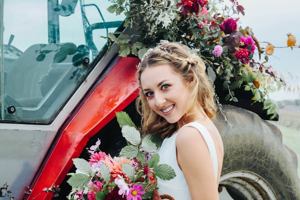 Bride posing near tractor