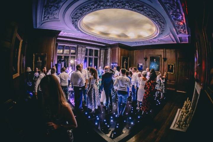 Guests Dancing in Wood Panelled Dining Room