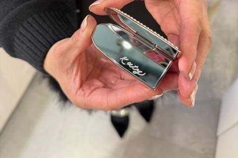 Engraved lipstick mirror.