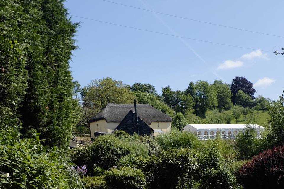 view from the gardens to the cider barn and marquee