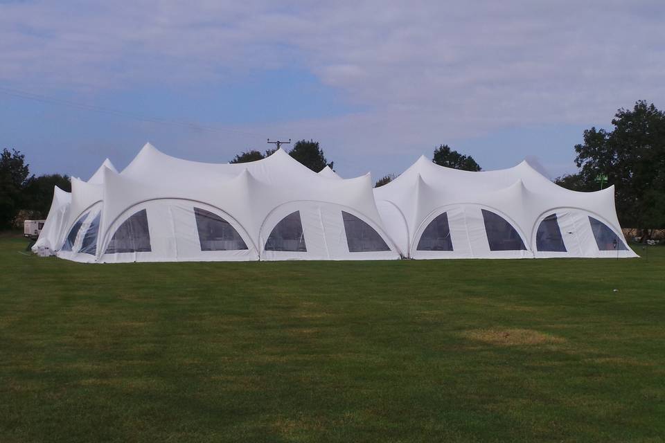 Adjoined trapeze marquees