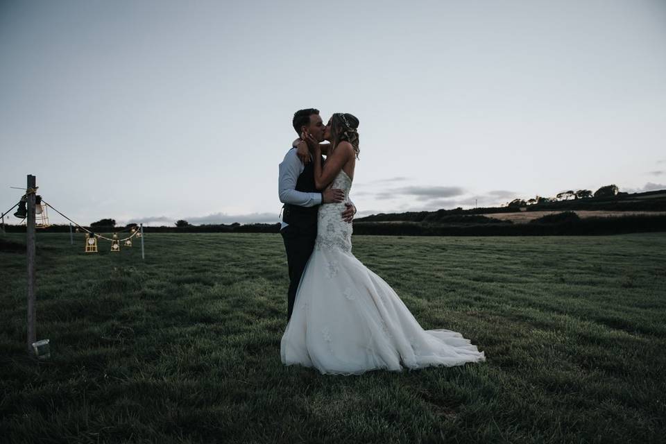 Couple kiss in field