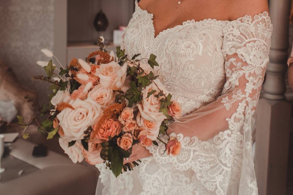 Smiles and holding bouquet