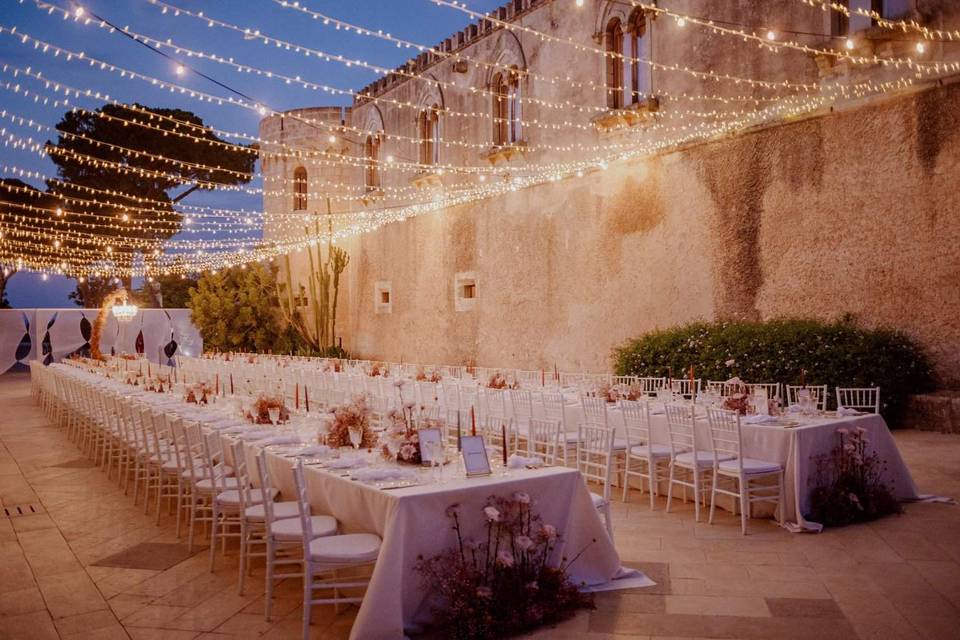 Long tables under festoon ligh