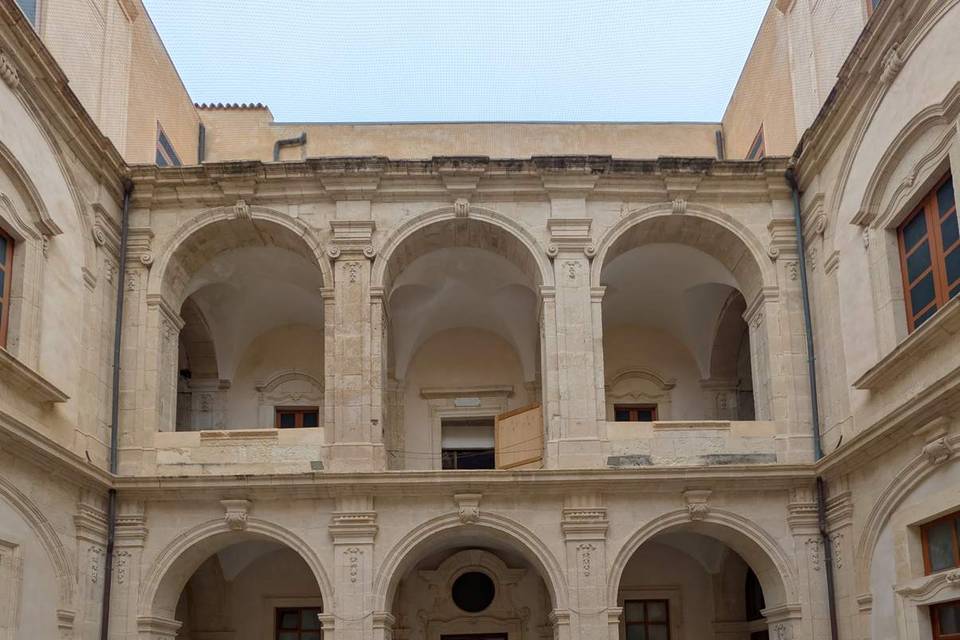 The arcaded courtyard of the former Liceo Gargallo, Ortigia
