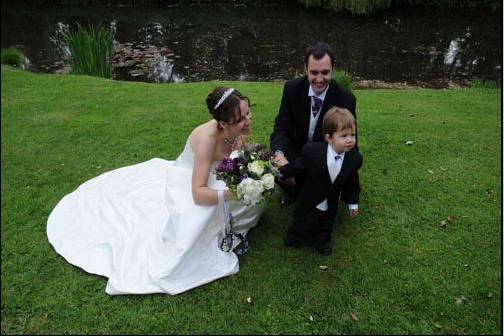 Bride and groom with child at wedding