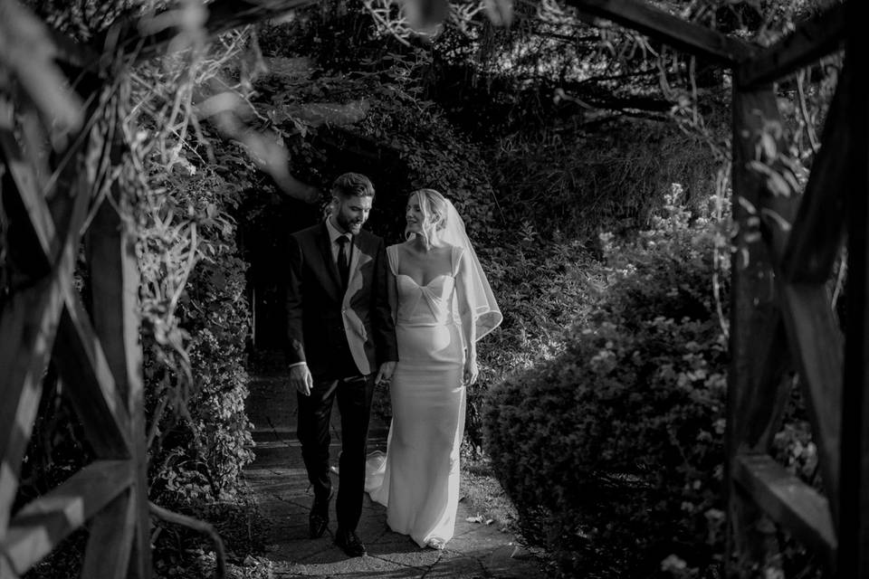 Wedding couple walking gardens