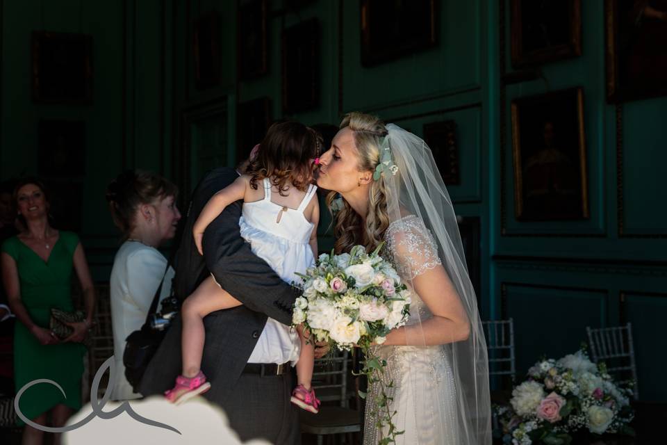 Bride kisses young guest