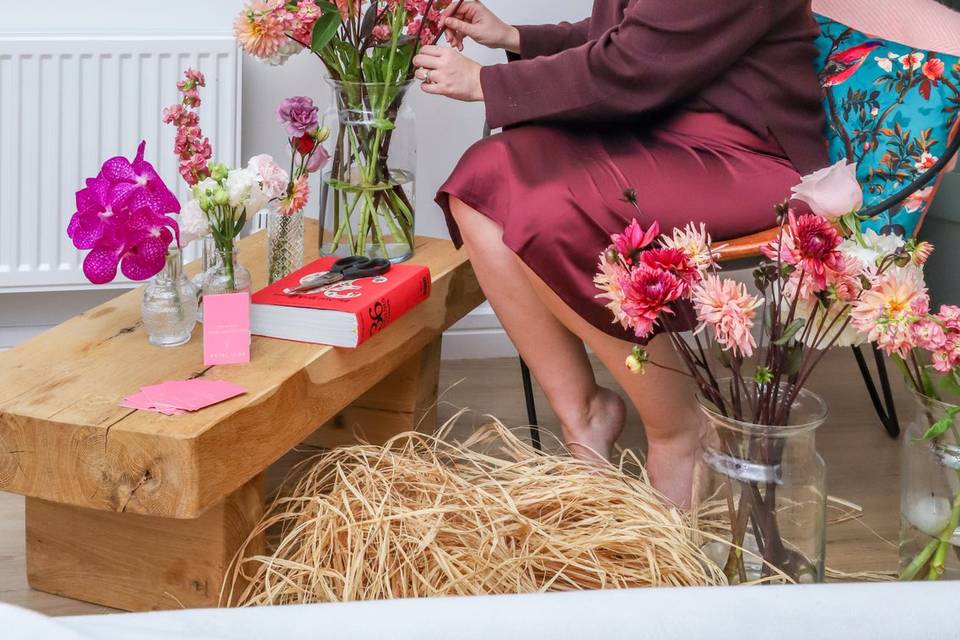 Woman arranging flowers on low table