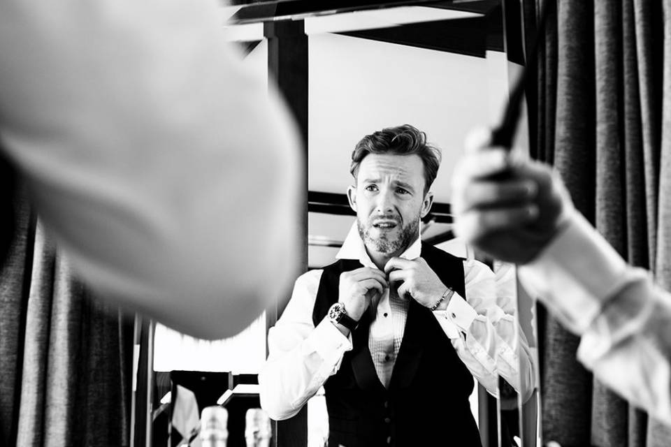 Groom looking at the mirror