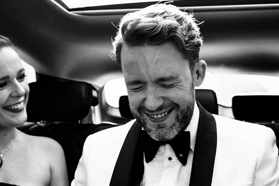 Groom laughing in the car