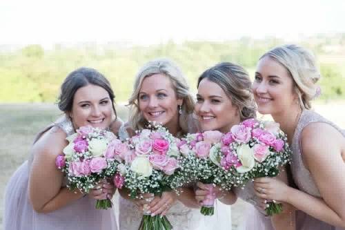 Holding pink bouquets