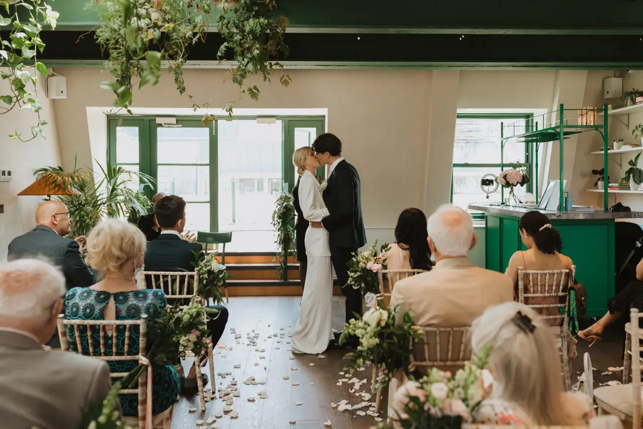 Bride and groom share first kiss inside the AllBright Mayfair Small London Wedding Venue