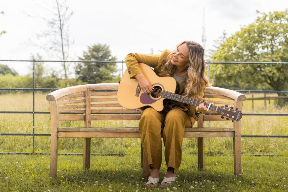 Alice playing the guitar