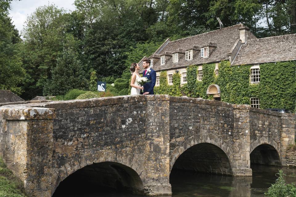 Couple standing on a stone bridge