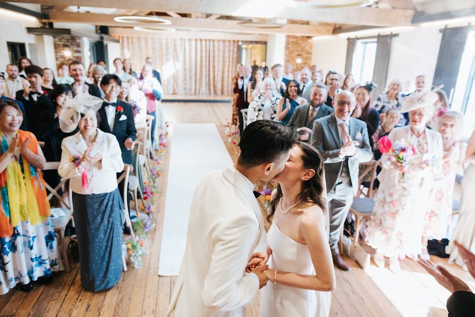 Ceremony kiss candid photo