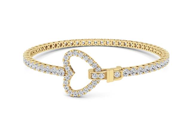 Heart diamond tennis bracelet in yellow gold