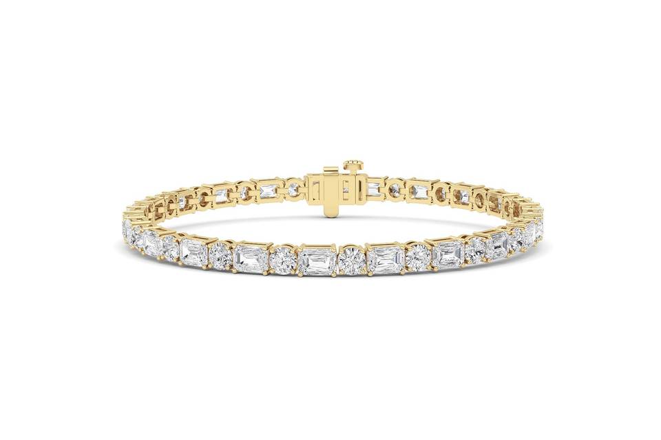 Emerald and round diamond tennis bracelet in yellow gold