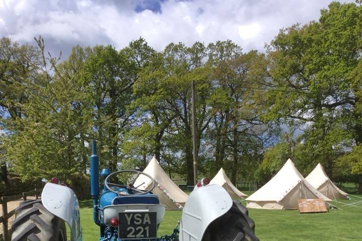 Vintage tractor and glamping tents