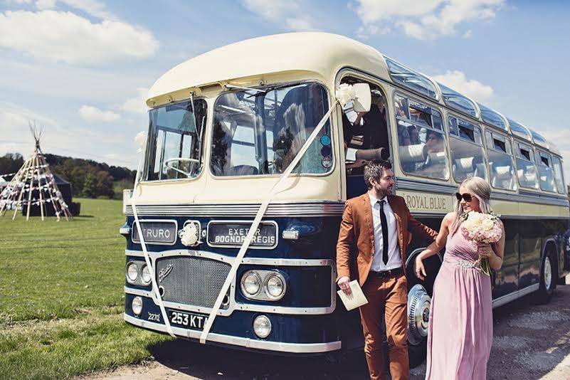 Vintage bus dropping off guests