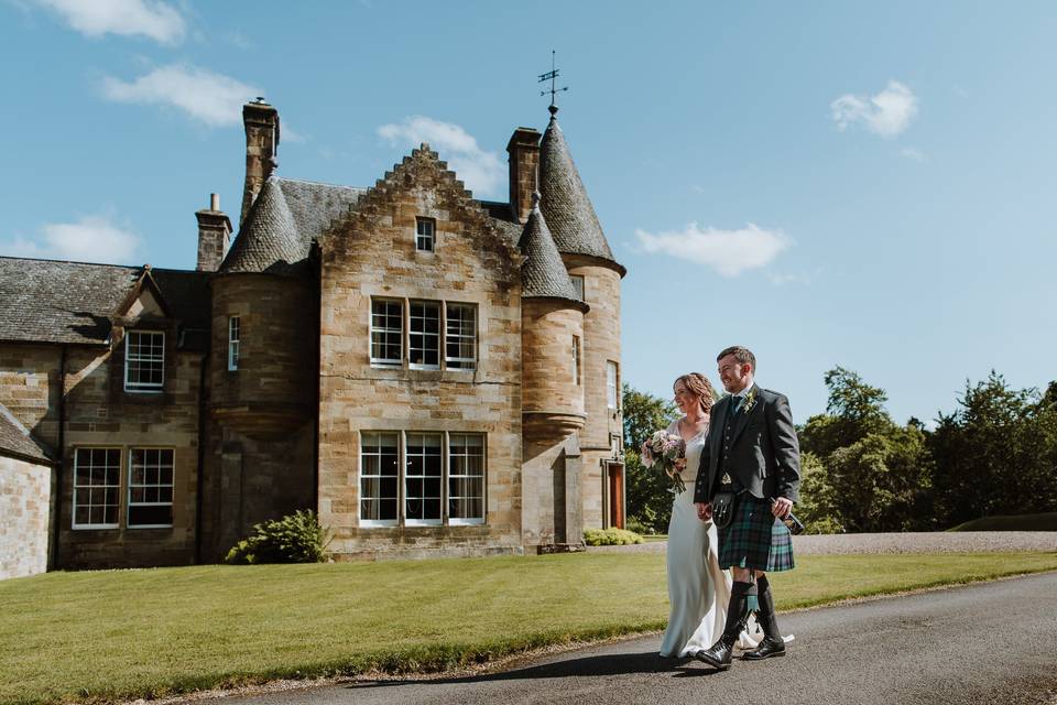 Newlyweds walking by house