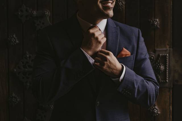 Groom adjusting suit