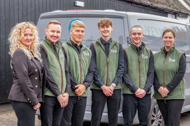 Catering team group portrait in front of a van