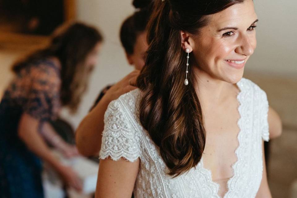 Close up bride getting dressed