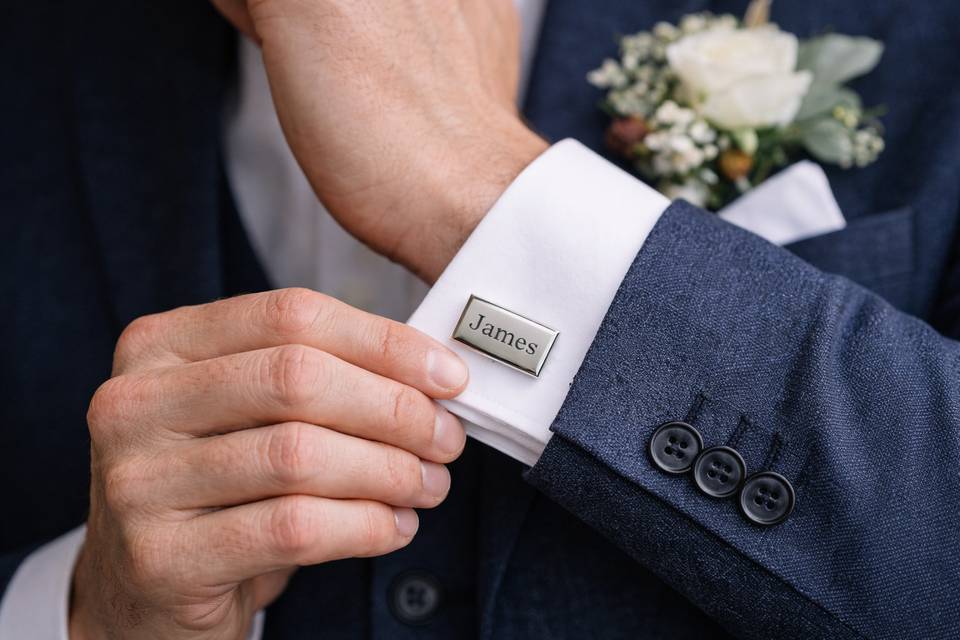 Groom adjusting cufflink